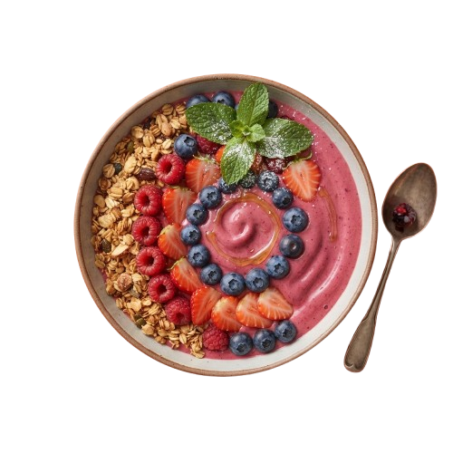 A white bowl filled with pink berry yogurt, topped with granola, fresh berries, and mint leaves, with a spoon beside it
