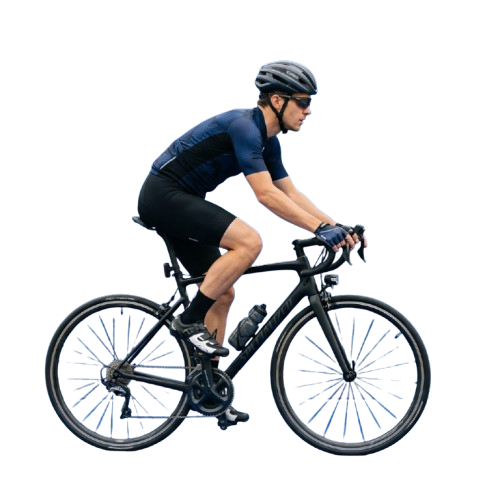 A person riding a road bike in a forward-leaning, aerodynamic position against a dark background