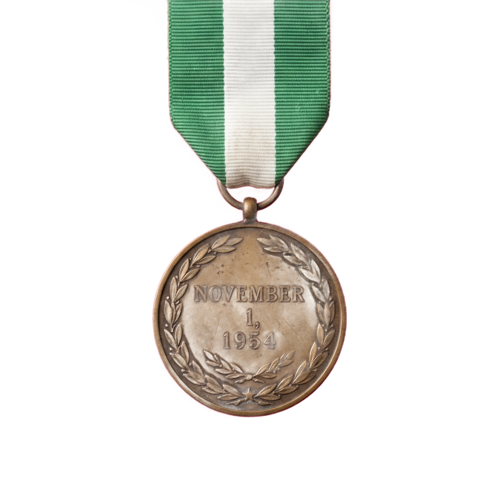 Bronze medal with laurel wreath and date November 1 1954, attached to green and white ribbon