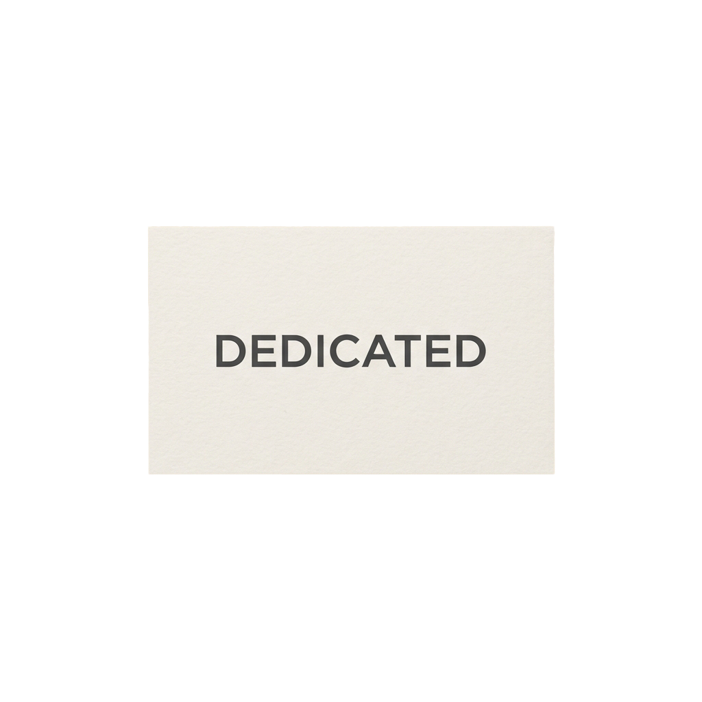 A white rectangular label with the word Dedicated in bold uppercase letters against a black background