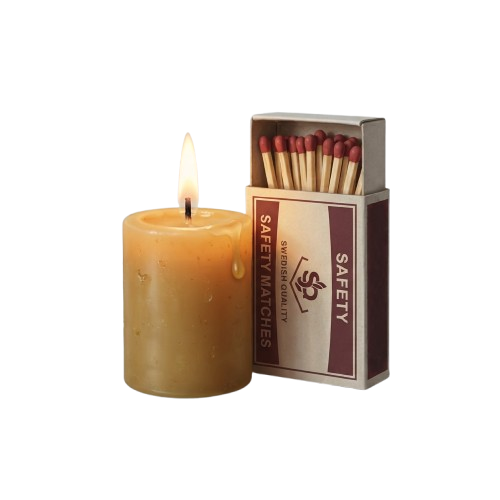 A lit candle next to a box of safety matches on a black background