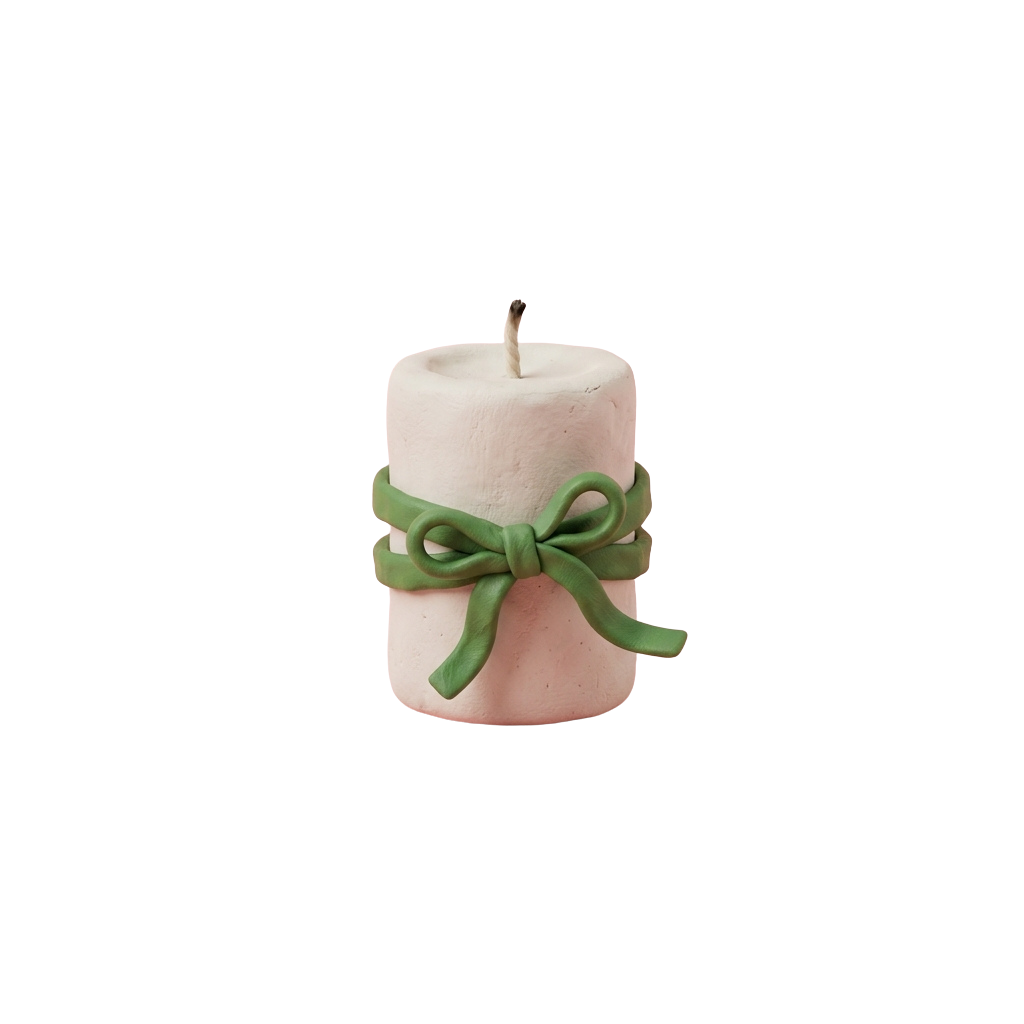 A small pink candle tied with a green ribbon bow around the middle