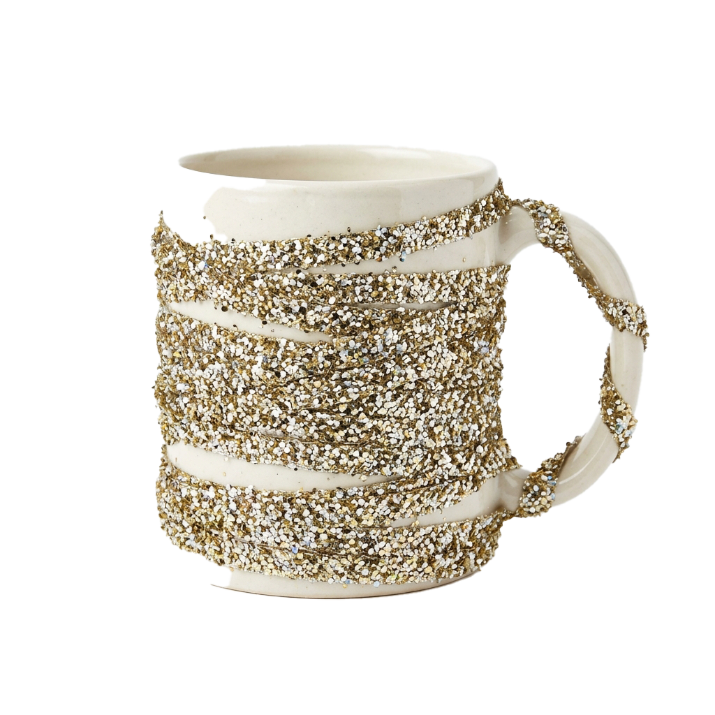 A ceramic mug with gold speckled design and a white base, featuring a handle and a wide rim.