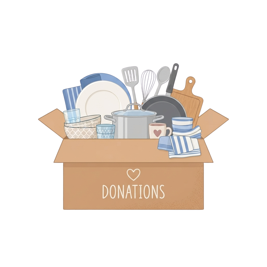 A cardboard box labeled donations filled with kitchen items like plates, pots, utensils, and mugs