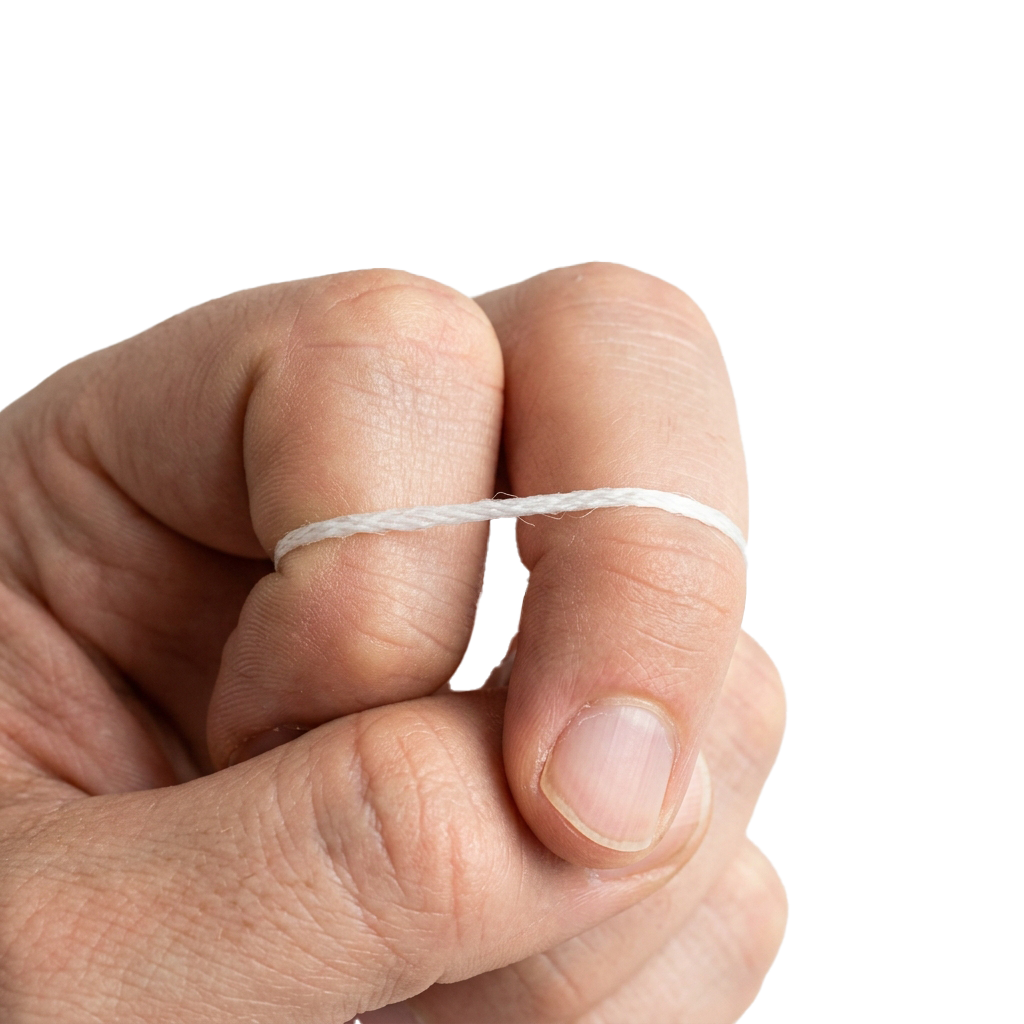 A close-up image of a finger wearing a thin white ring.