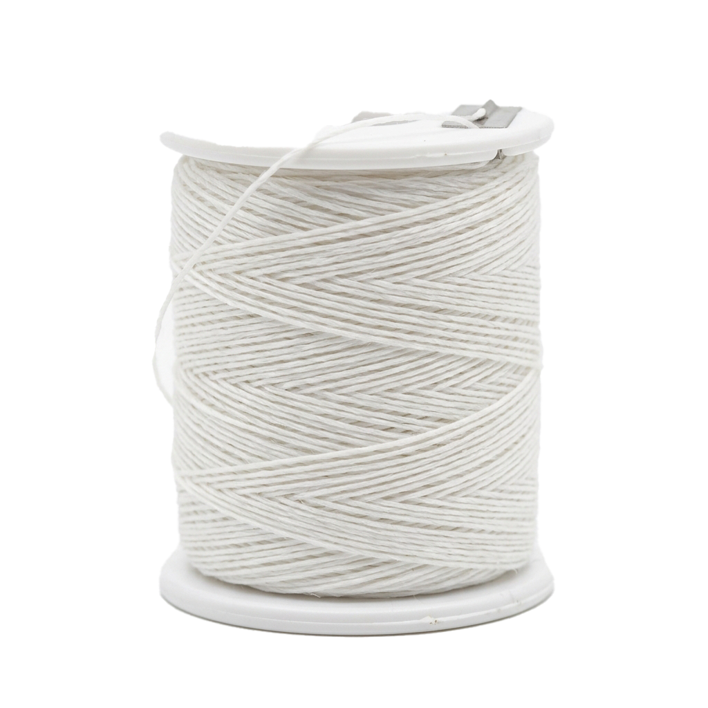 A white spool of embroidery floss with thread neatly wound around a plastic bobbin