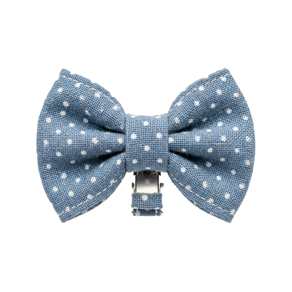 Light blue bow tie clip with white polka dots on a black background
