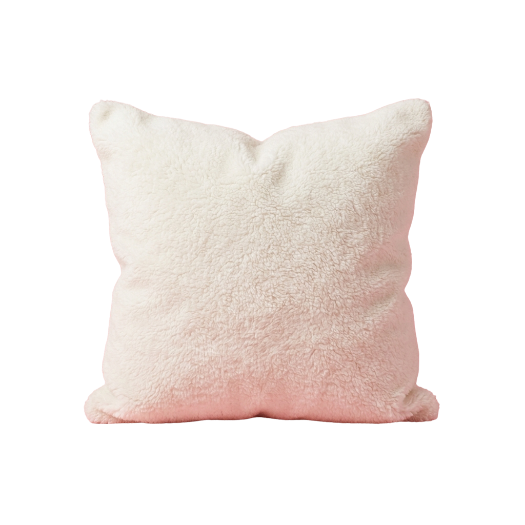 A plush, light pink pillow with a fuzzy texture against a black background