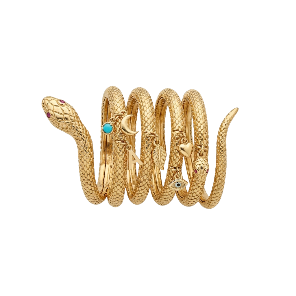 A detailed golden snake ring with textured scales, gemstone eyes, and symbolic charms.