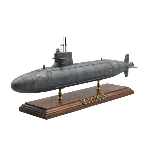 A realistic model submarine displayed on a wooden base with a plaque.