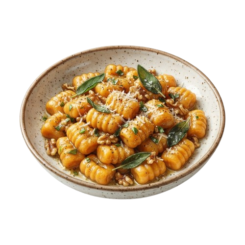 A white speckled bowl filled with golden gnocchi topped with fresh sage leaves and grated cheese