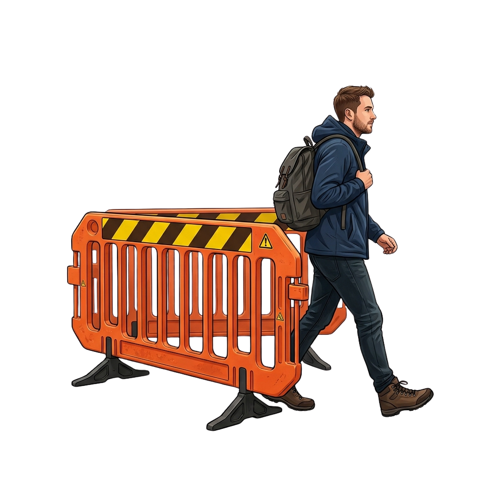 A person in a dark jacket and backpack walking beside an orange and black striped construction barrier