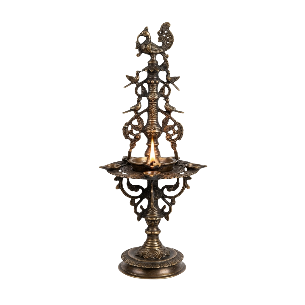 Intricate brass oil lamp with ornate carvings and a lit flame on a decorative tray