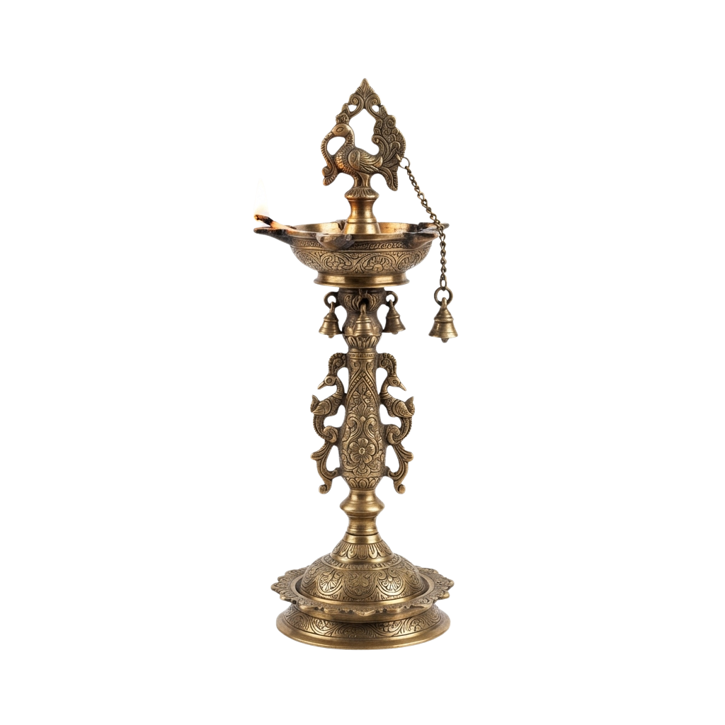 An ornate brass oil lamp with intricate designs and small bells hanging from its sides