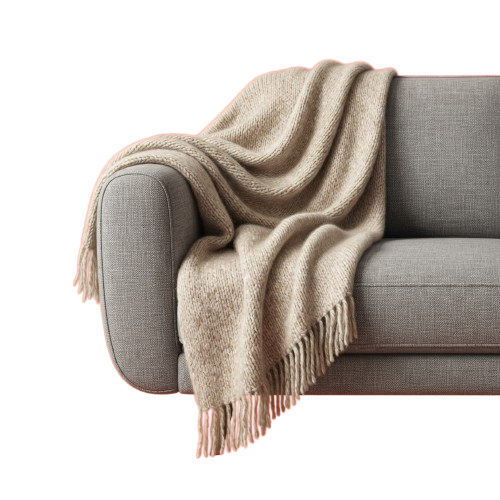 A light beige knitted throw blanket with pink edging draped over a gray sofa arm.