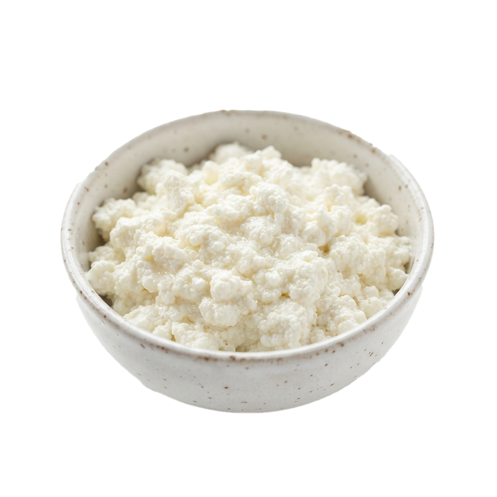 A white ceramic bowl filled with crumbly cottage cheese against a black background