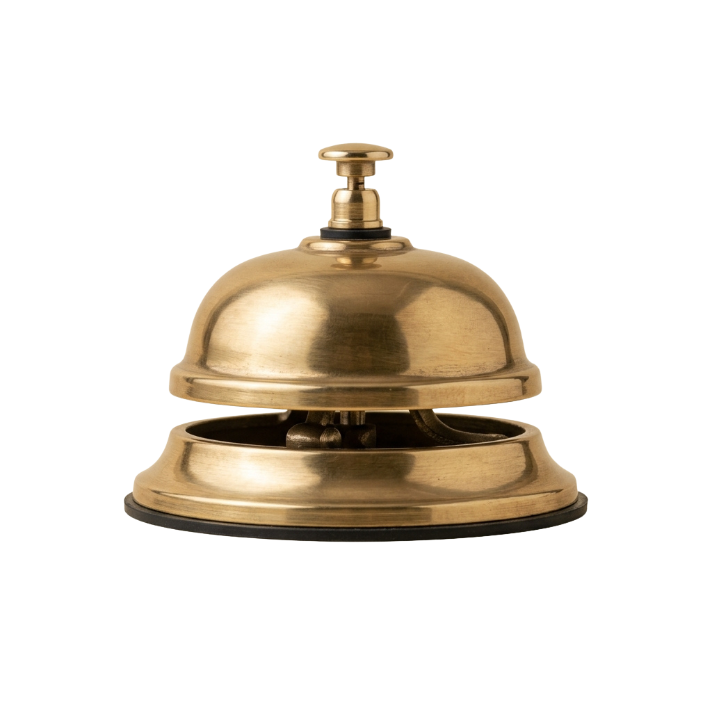 A polished brass bell with a dome-shaped top and a button on its stem against a dark background