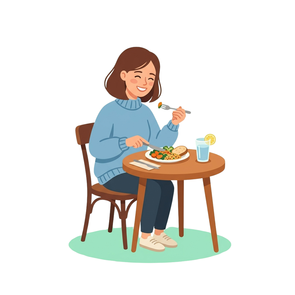 A smiling woman eating a meal with a fork at a small wooden table, with a glass of water and lemon slice nearby
