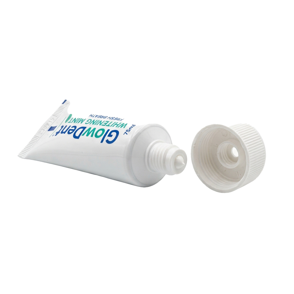 A tube of whitening mint toothpaste with its white cap removed, shown against a black background