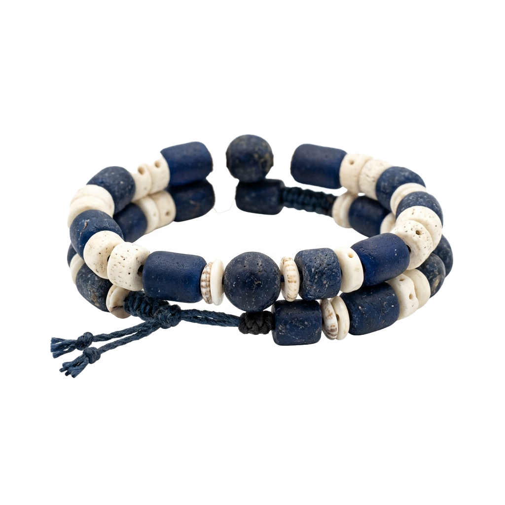 A handcrafted bracelet with alternating dark blue and cream beads, featuring cylindrical and spherical shapes.
