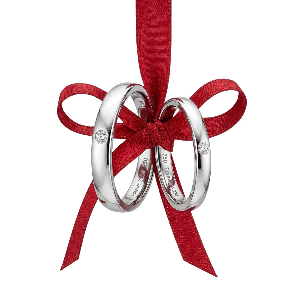 Two silver wedding rings tied together with a red velvet ribbon bow against a black background