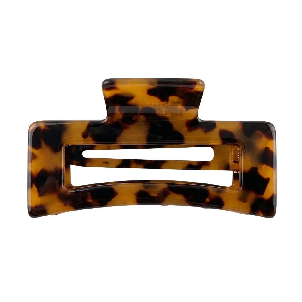 A pair of tortoiseshell patterned hair clips with a clear center slot for holding hair.