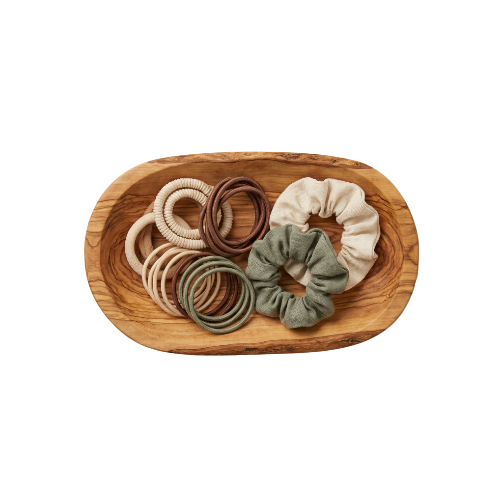 Wooden bowl containing six hair scrunchies and four elastic headbands in various colors