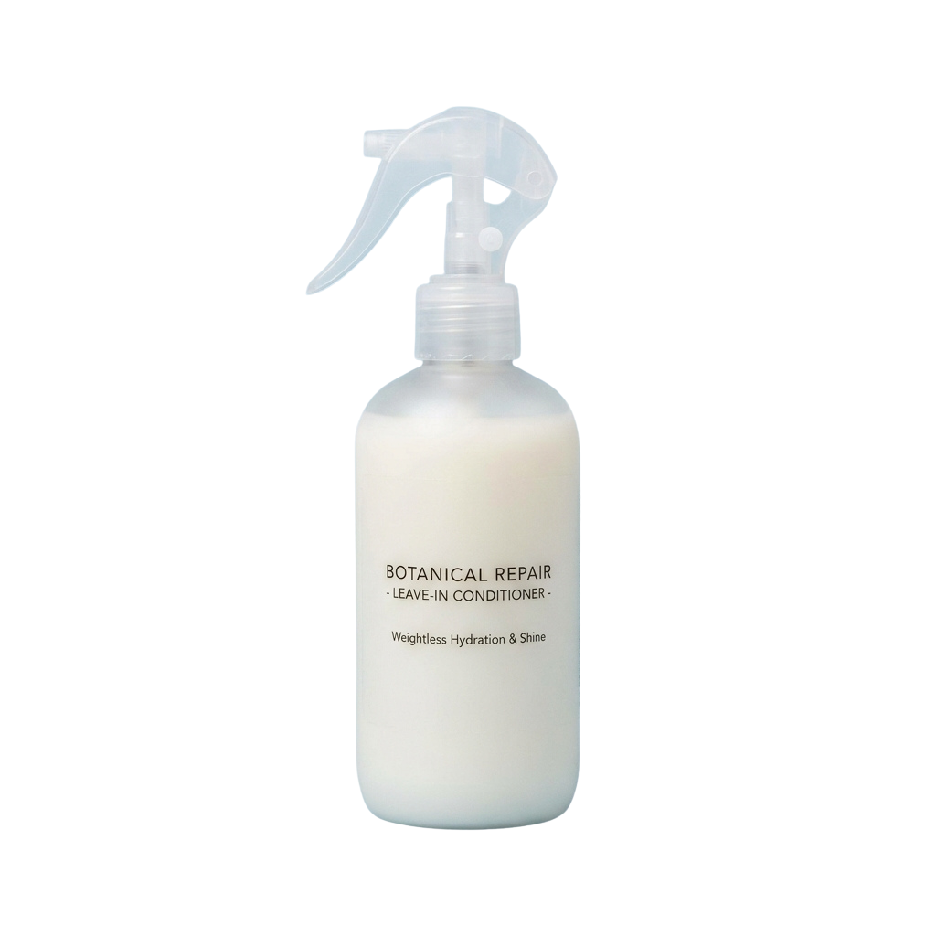 White spray bottle labeled Botanical Repair Leave-In Conditioner with weightless hydration and shine
