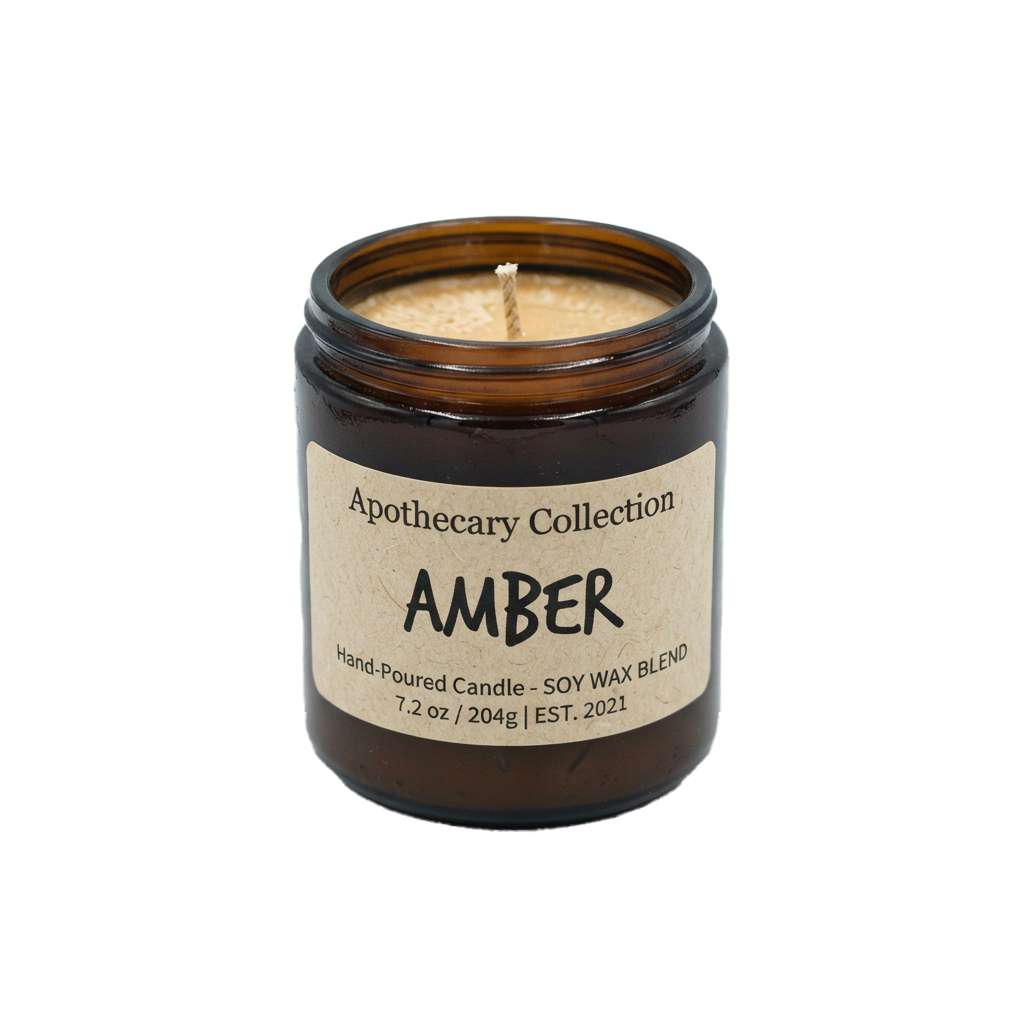 A small amber-scented candle in a dark glass jar with a hand-poured soy wax blend label.