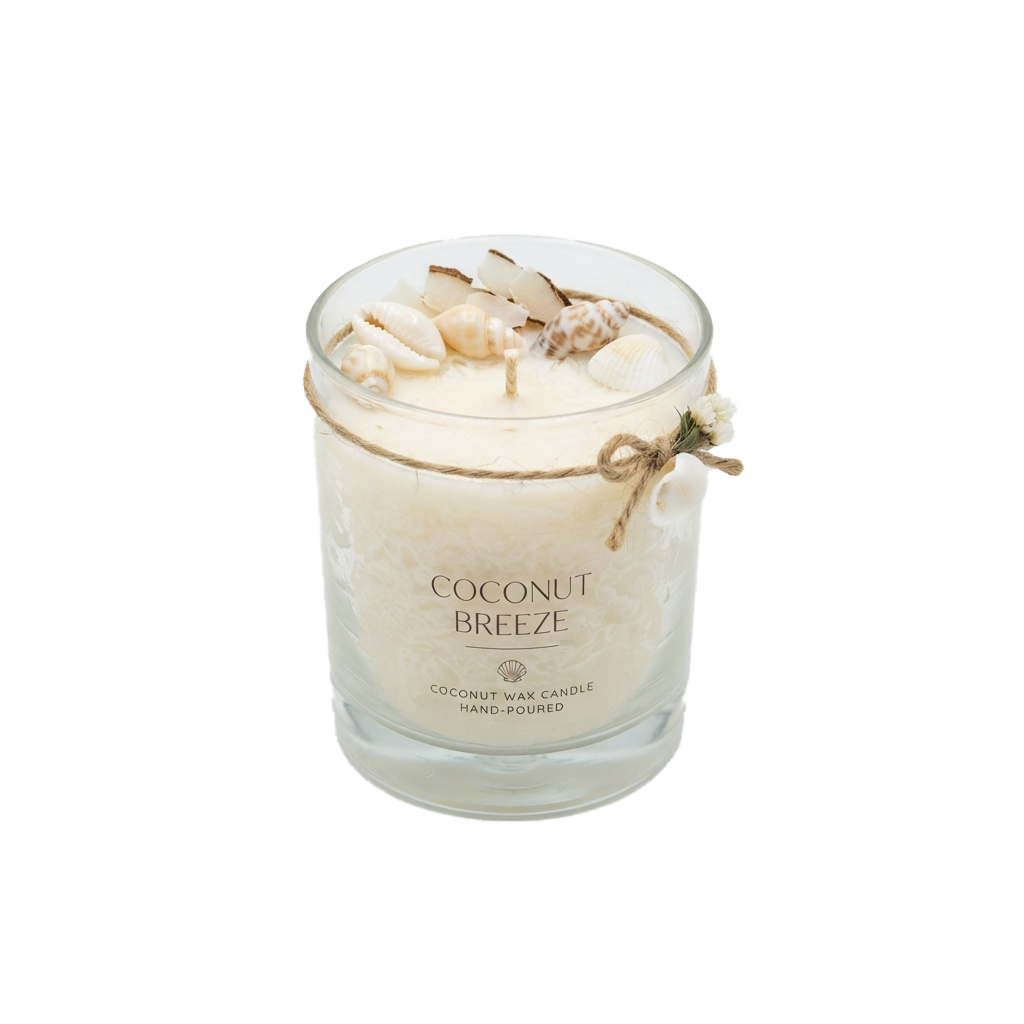 A coconut-scented candle in a glass jar with seashells and twine decoration