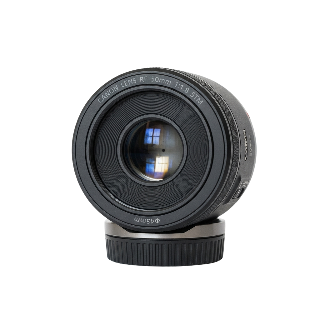 A black Canon RF 50mm f1.8 STM lens with a matching lens hood attached