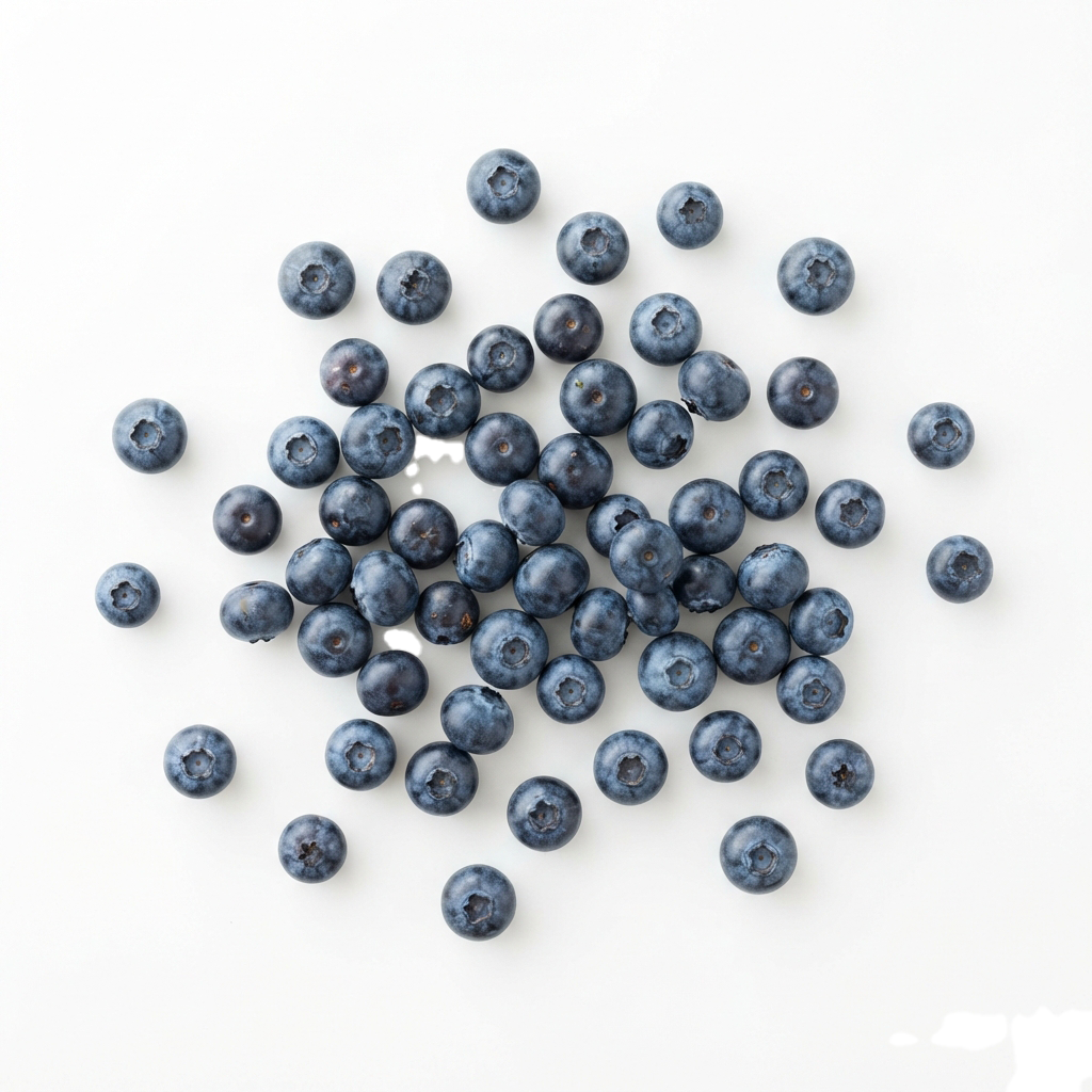 A collection of fresh blueberries spread across a light surface