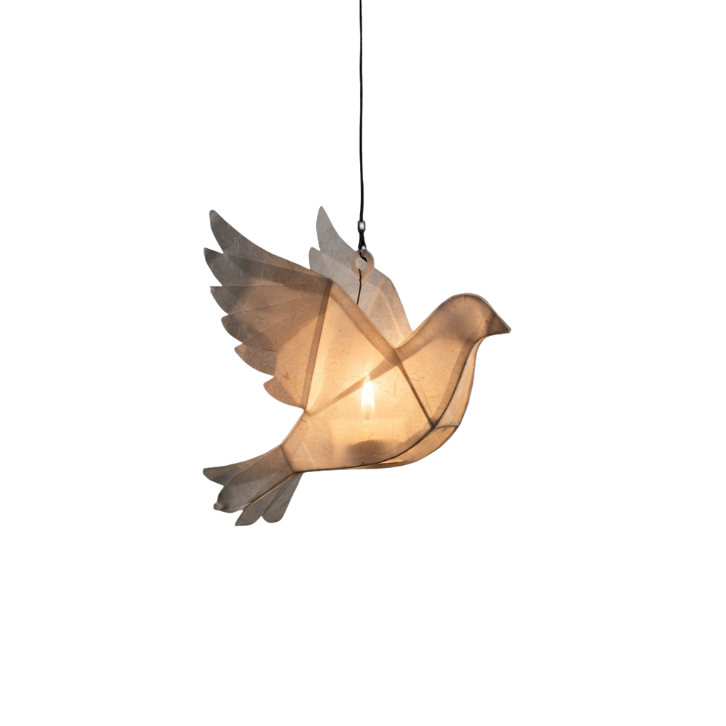 A glowing paper dove with outstretched wings hanging from a black ceiling against a dark background