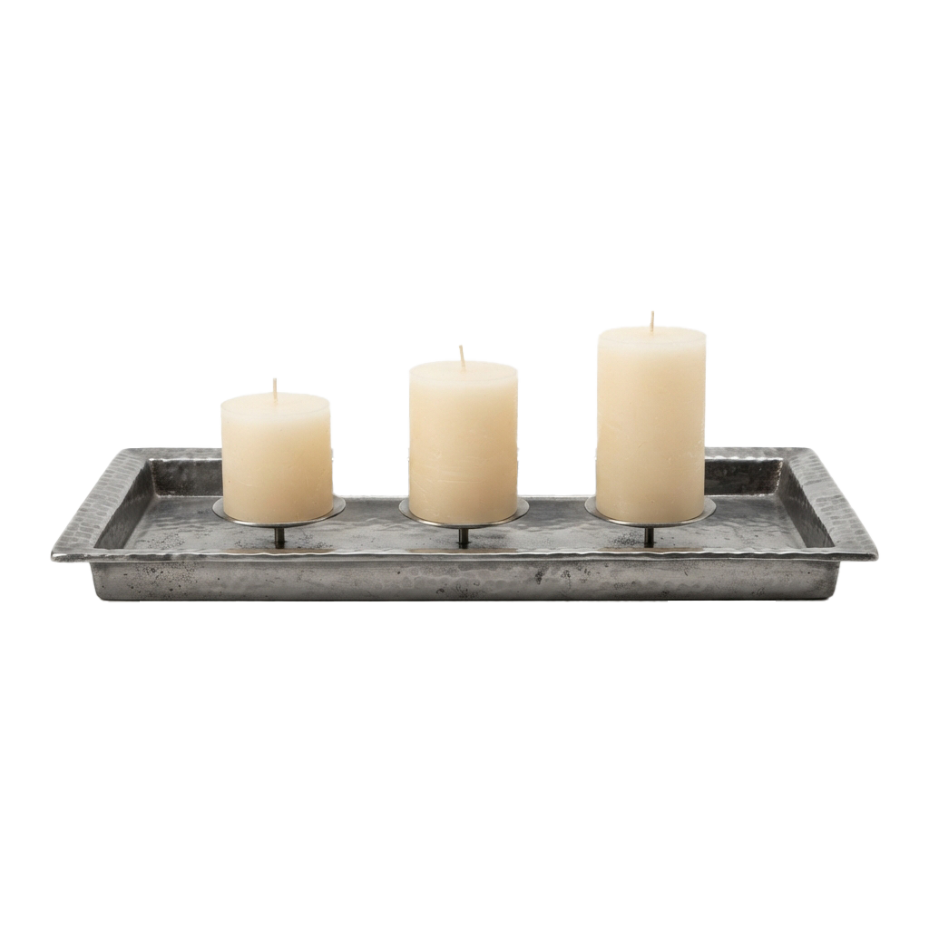 Three white candles placed in a rustic metal rectangular tray on a black background