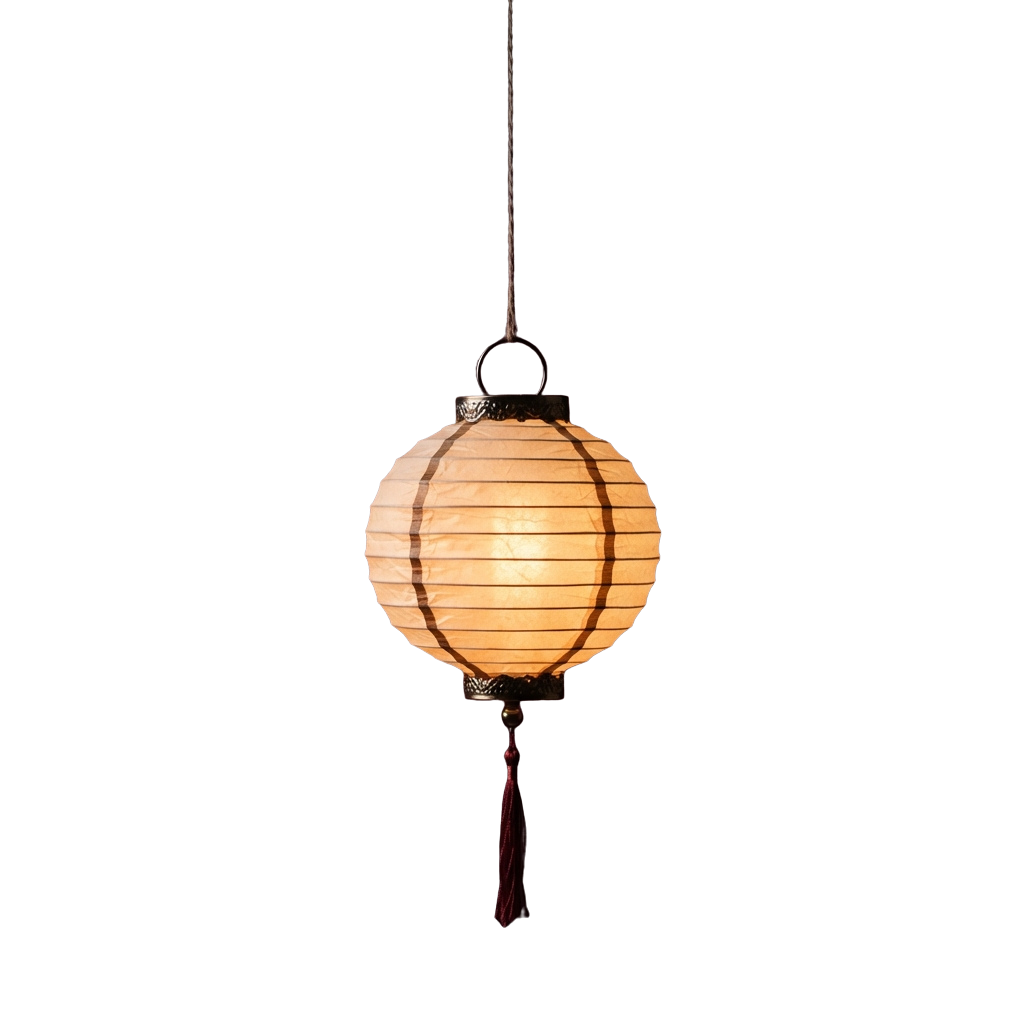 A glowing round paper lantern hanging from a black cord against a dark background