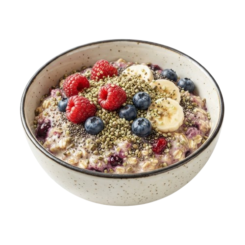 Bowl of oatmeal topped with blueberries, raspberries, banana slices, and seeds