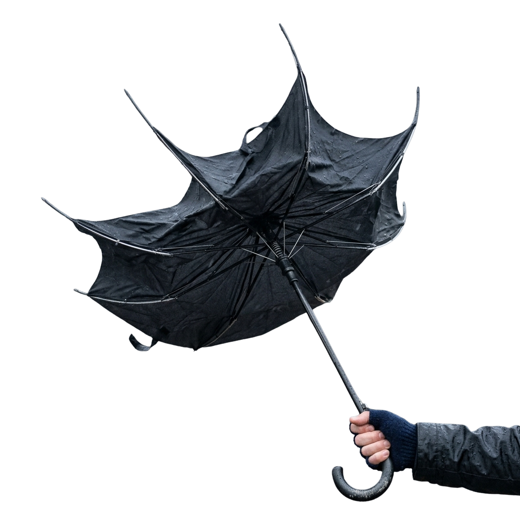 A person holding a black umbrella being blown inside out by strong wind