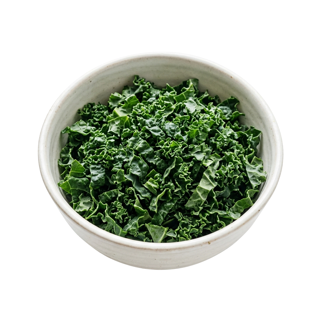 A white bowl filled with finely chopped green kale leaves