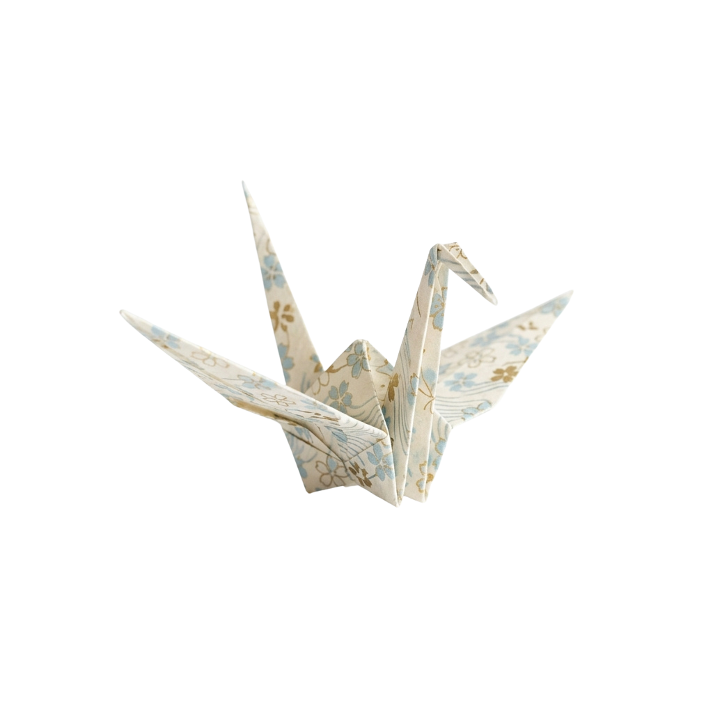 Origami paper crane with light blue and beige floral design on white paper