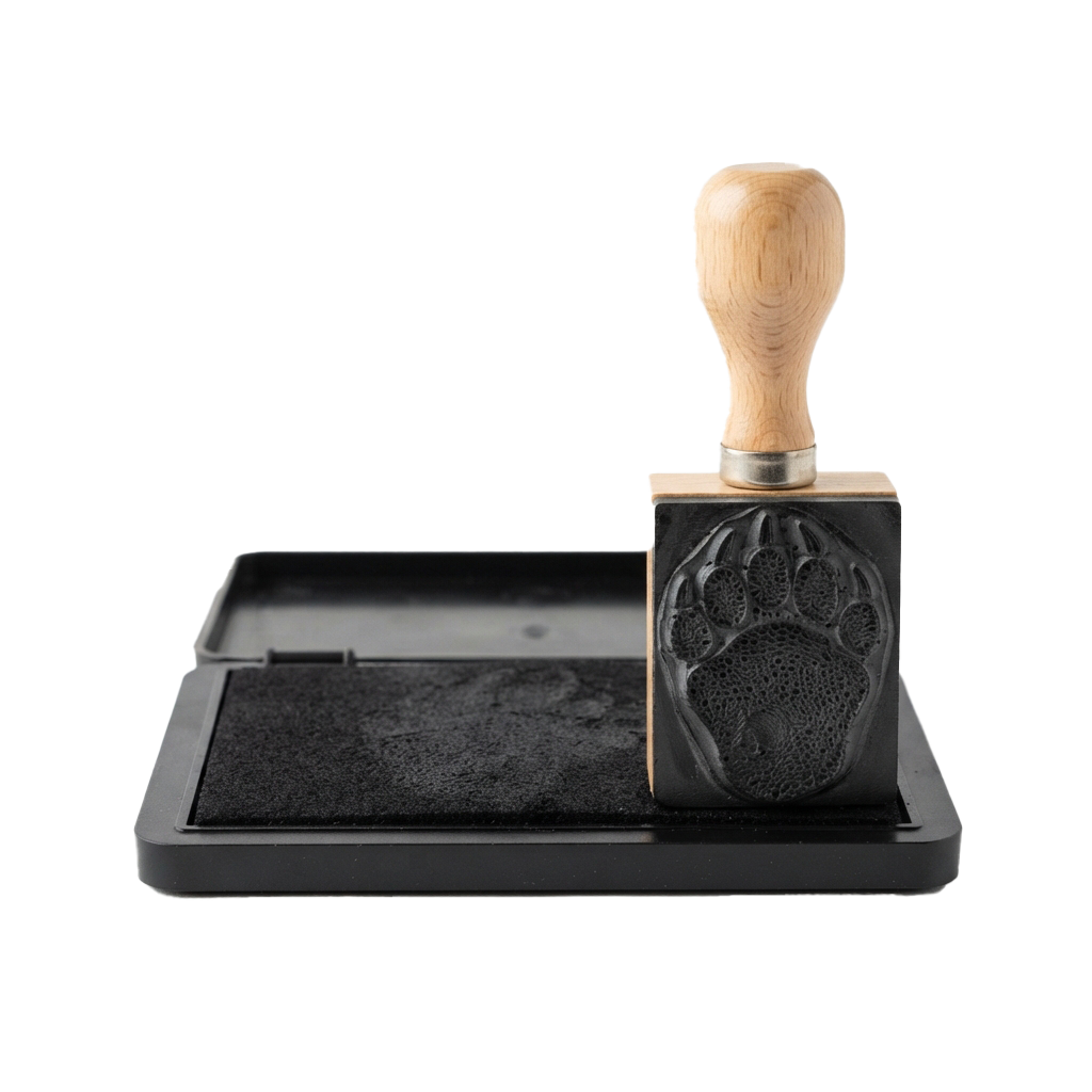 Wooden handled coffee grinder with paw print pattern on black base