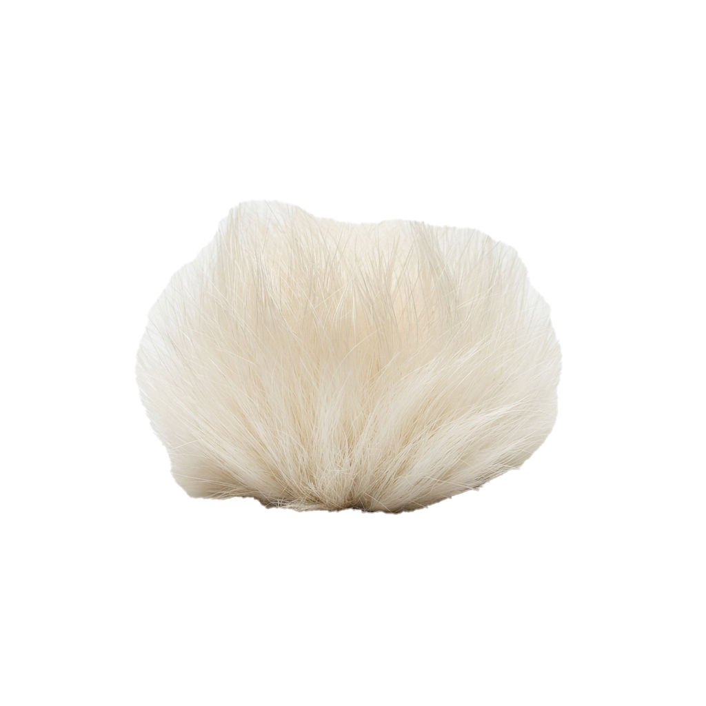 A close-up image of a soft white fluffy makeup brush with a rounded brush head.