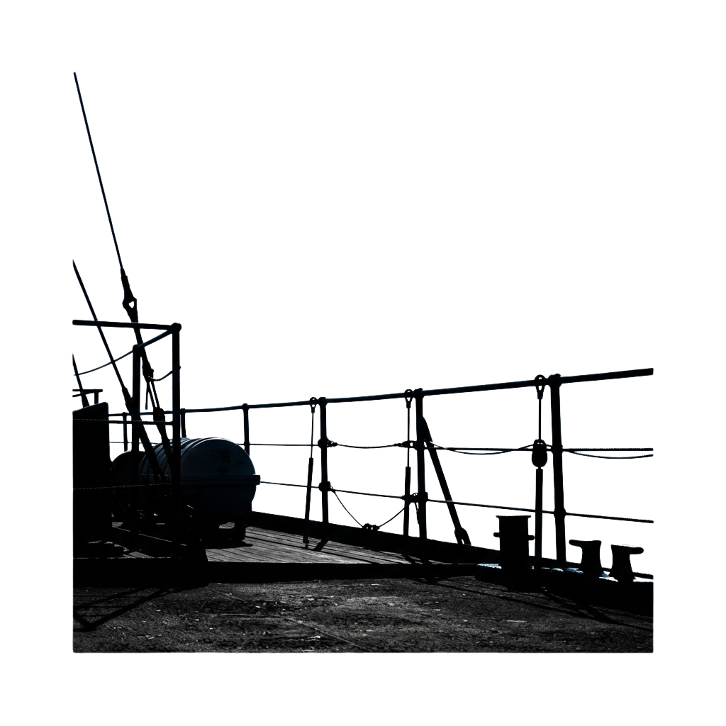 A worker in protective gear and helmet stands near a large industrial crane structure at night.