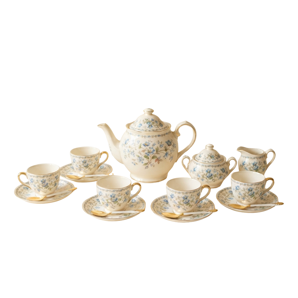 A vintage-style tea set featuring a teapot, cream pitcher, sugar bowl, cups, saucers, and spoons with blue floral patterns on cream background