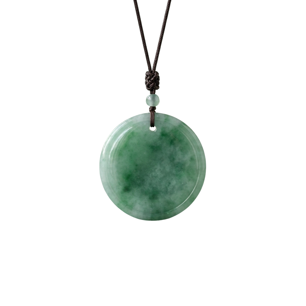 Round green jade pendant on a cord necklace with a small bead closure