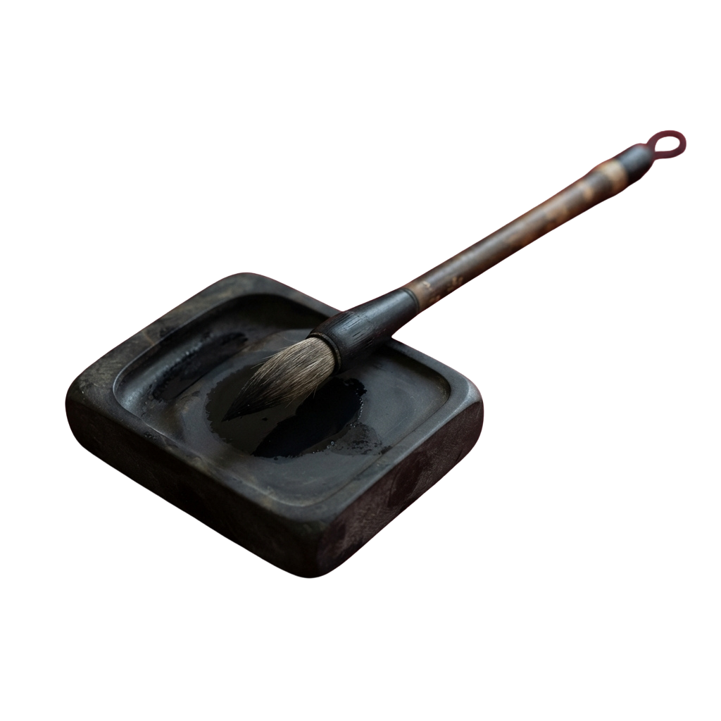 A calligraphy brush with a wooden handle resting in a dark inkwell with a circular depression