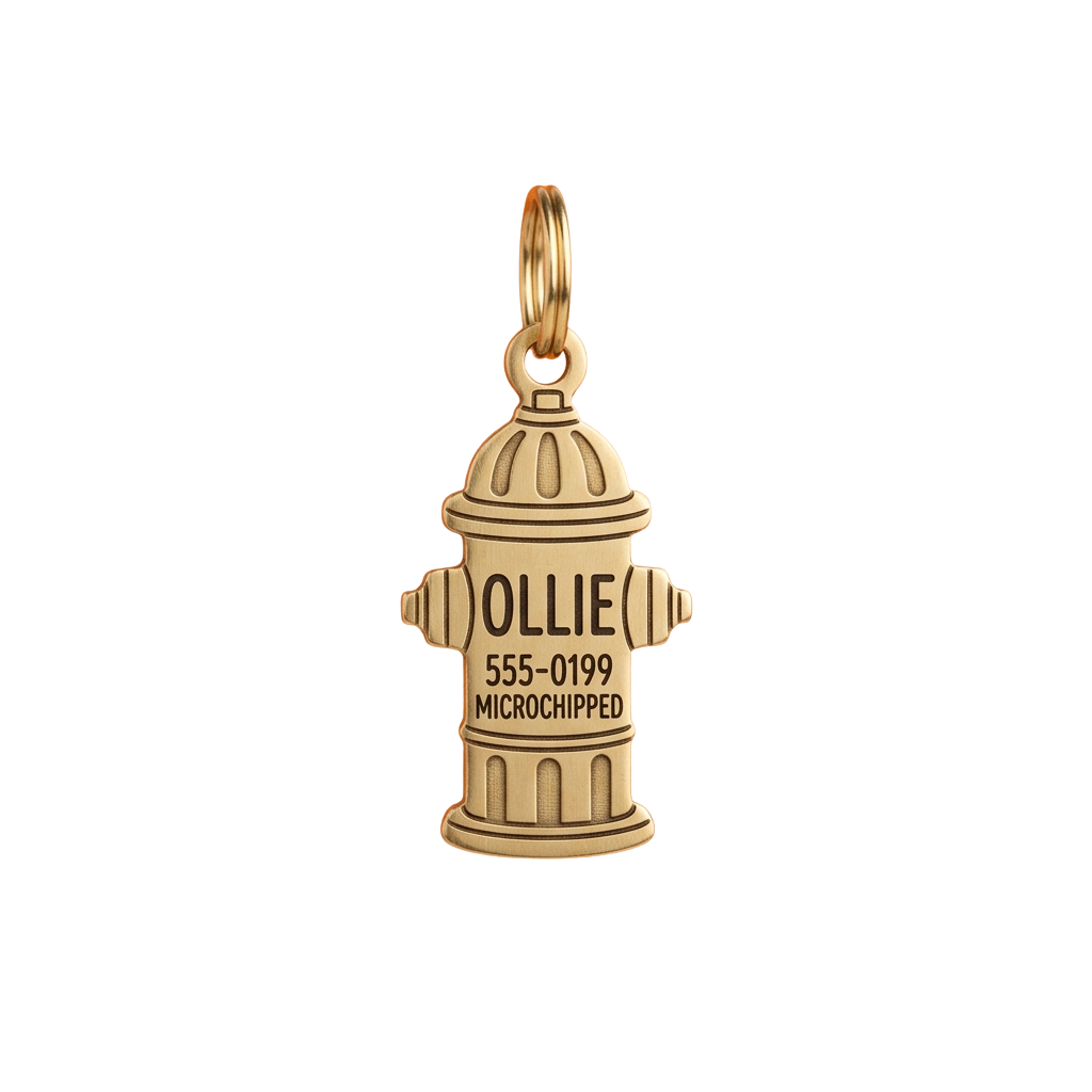 A gold-colored keychain featuring a fire hydrant design with the name Ollie and a phone number 555-0199 for a microchipped pet.
